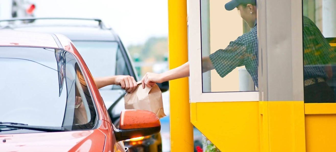 Person at drive-thru getting fast food