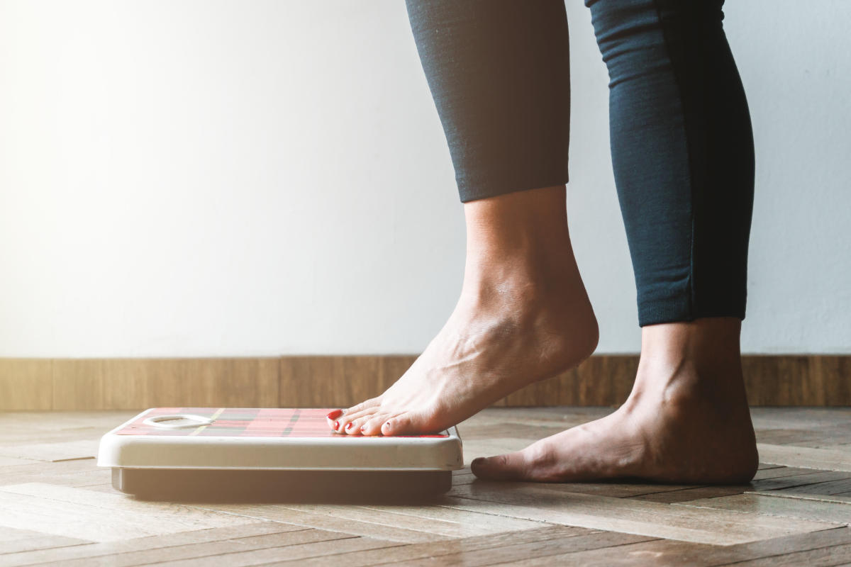 Person using scale to see her weigh