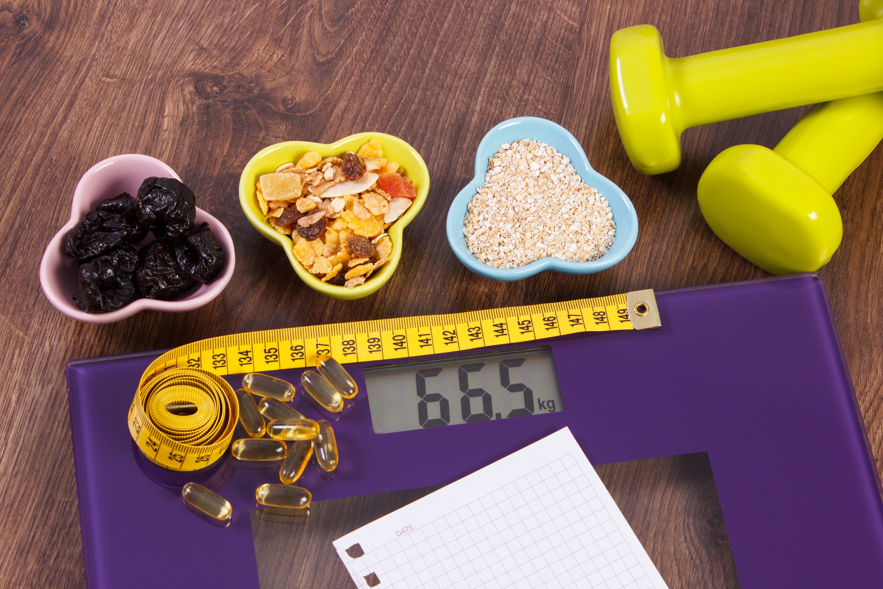 Purple scale, dumbbell set and measuring tape